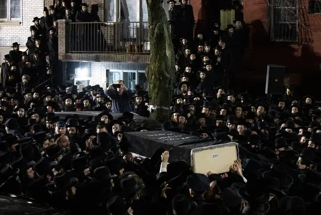 Orthodox Jewish men carry Moshe Deutsch's casket outside a Brooklyn synagogue following his funeral last week
